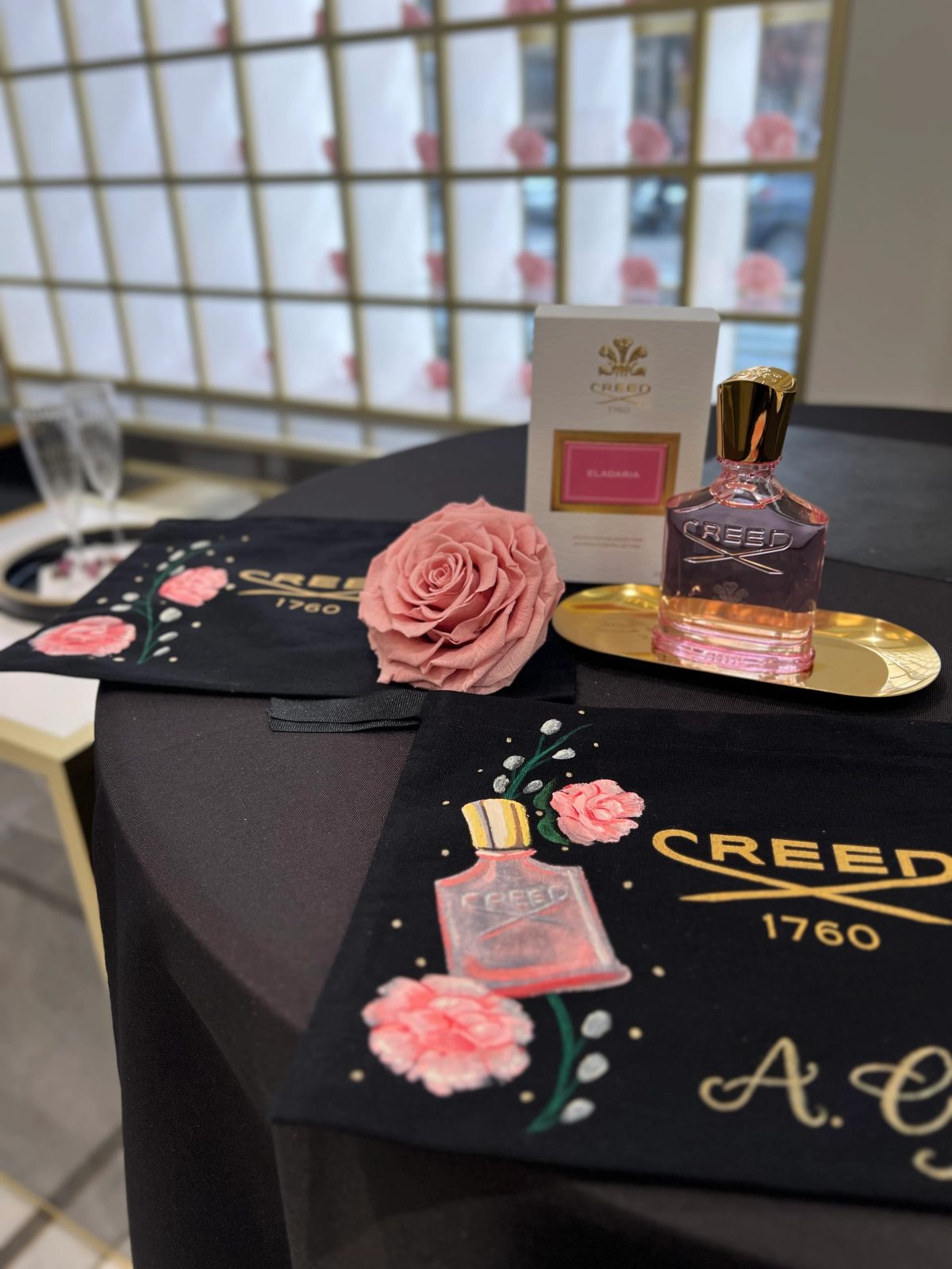 Painted flowers and personalized lettering on black fragrance packaging