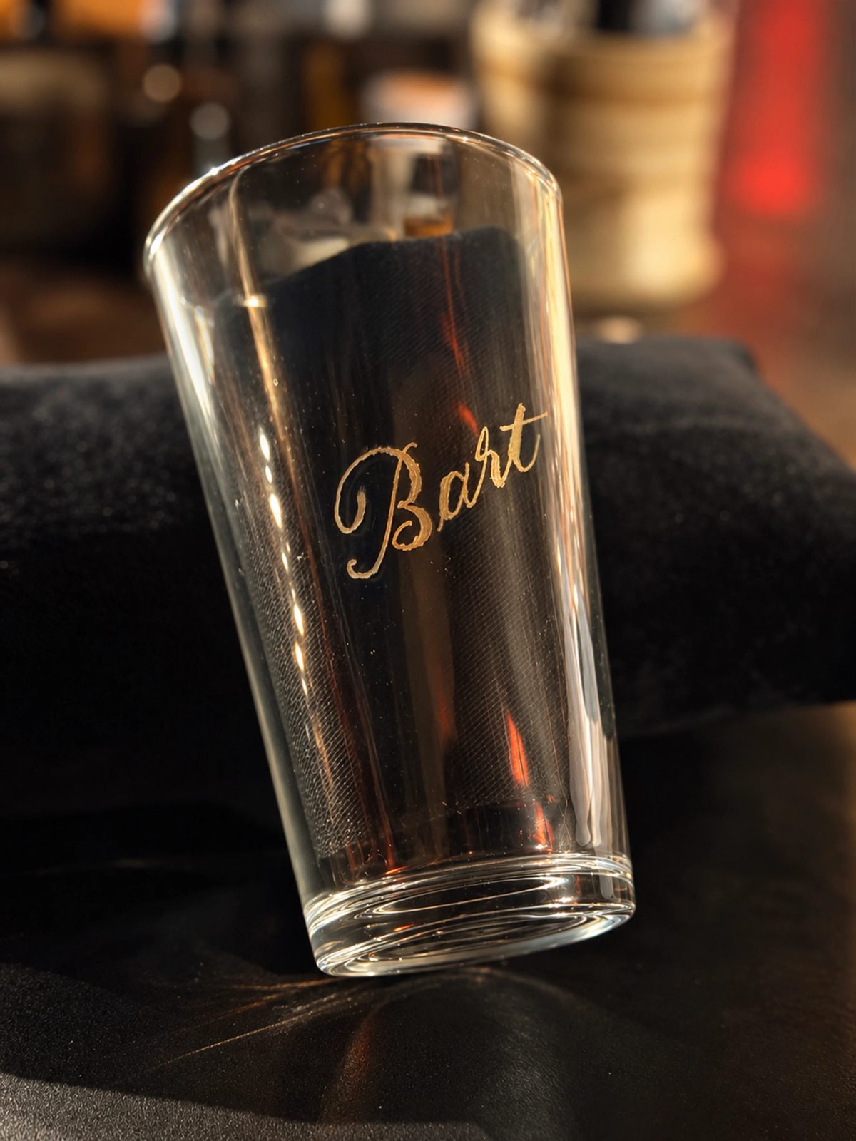 Hand-engraved lettering on a drinking glass