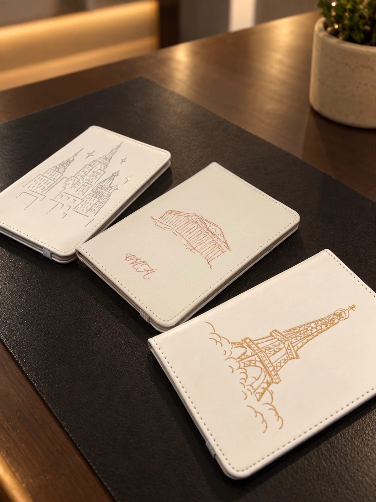 Fine architectural and botanical illustration on a small white notebook