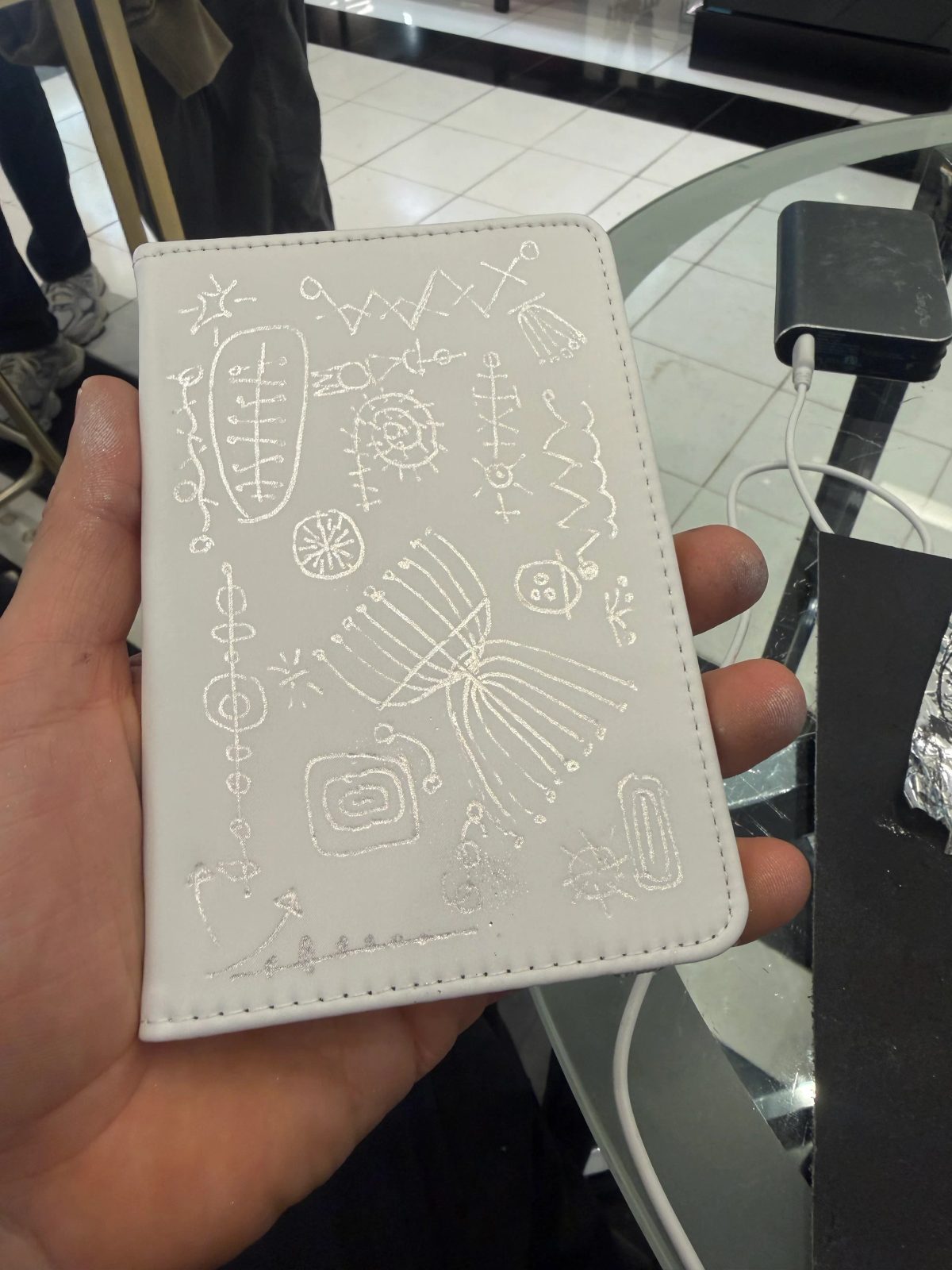 Fine architectural and botanical illustration on a small white notebook
