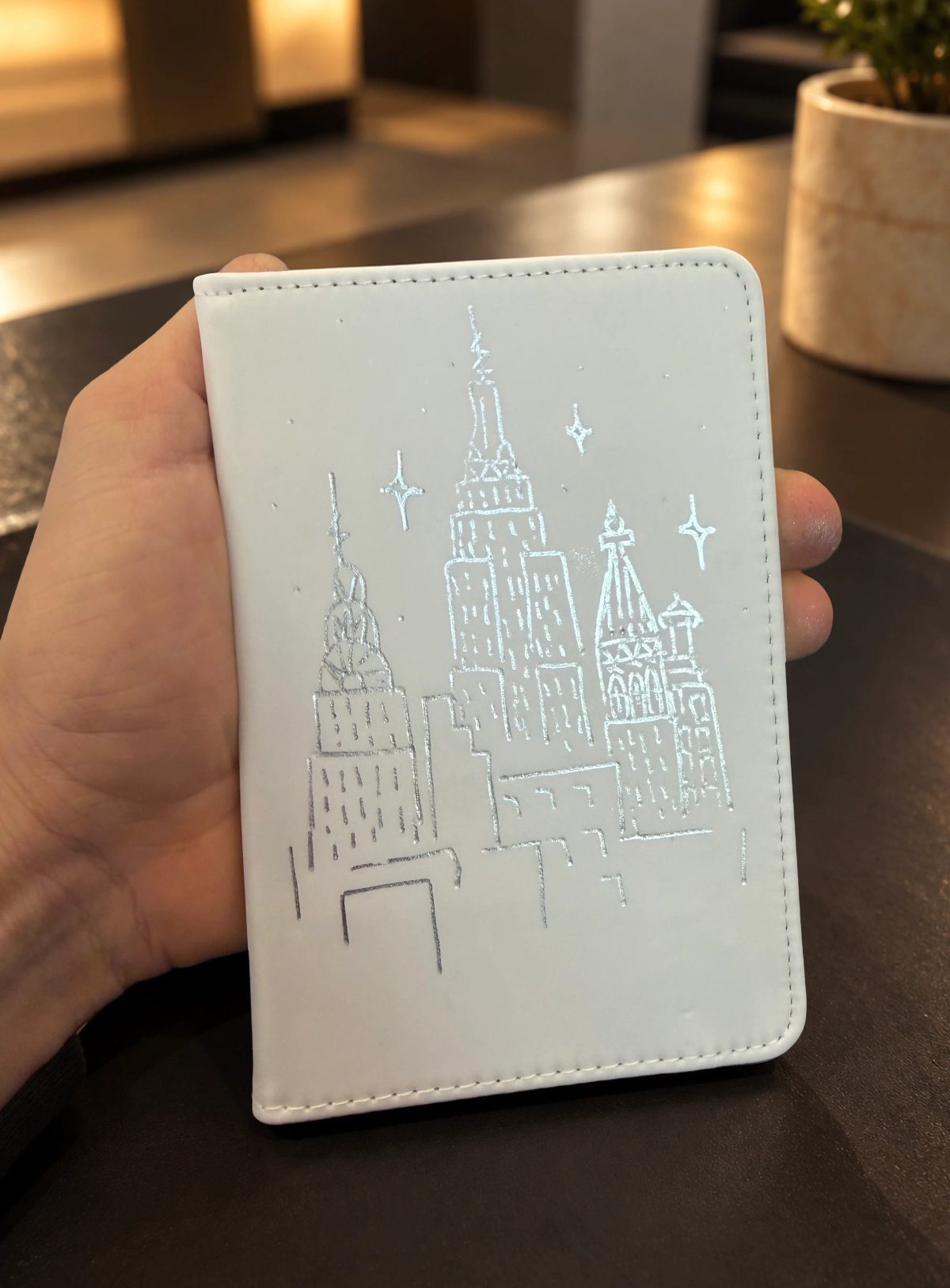 Fine architectural and botanical illustration on a small white notebook