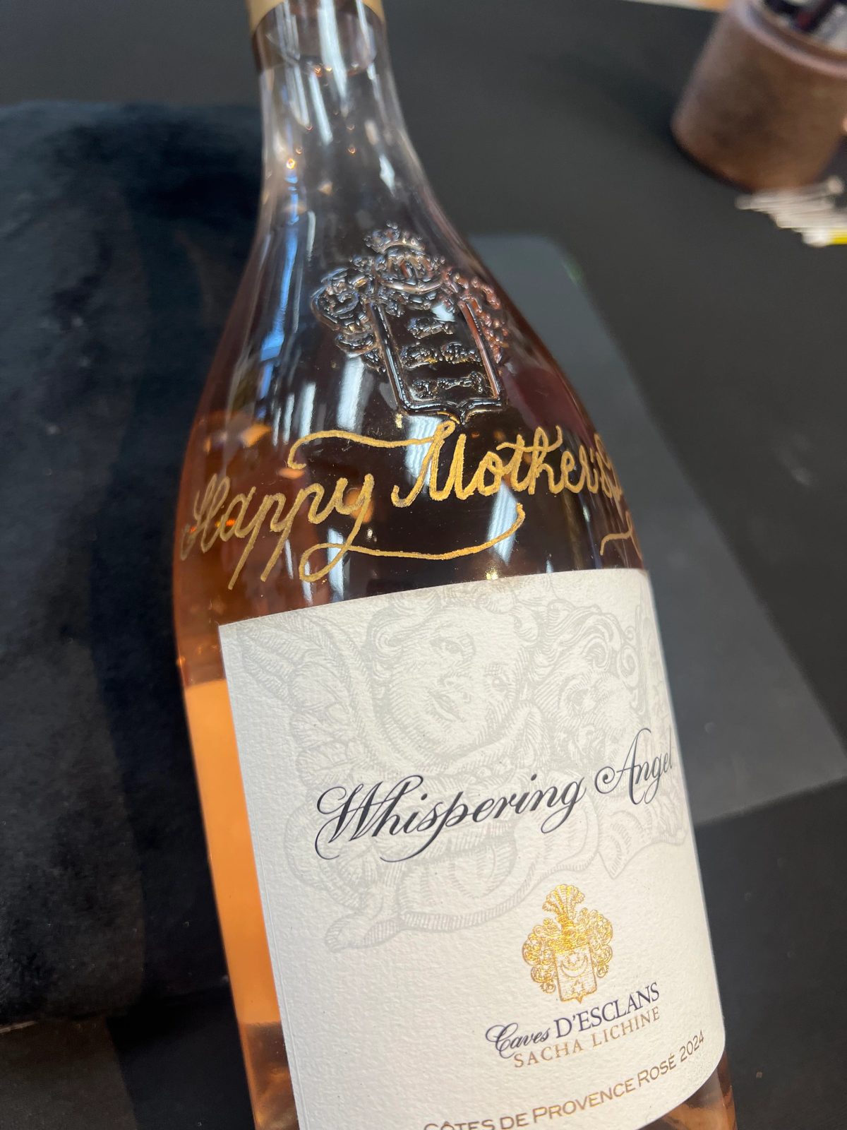 Wine bottle personalized with engraved lettering and decorative detail