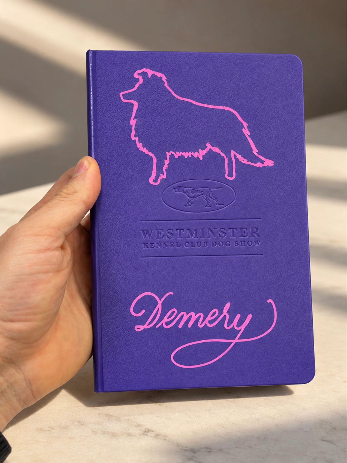 Purple notebook with a pink dog outline and personalized lettering