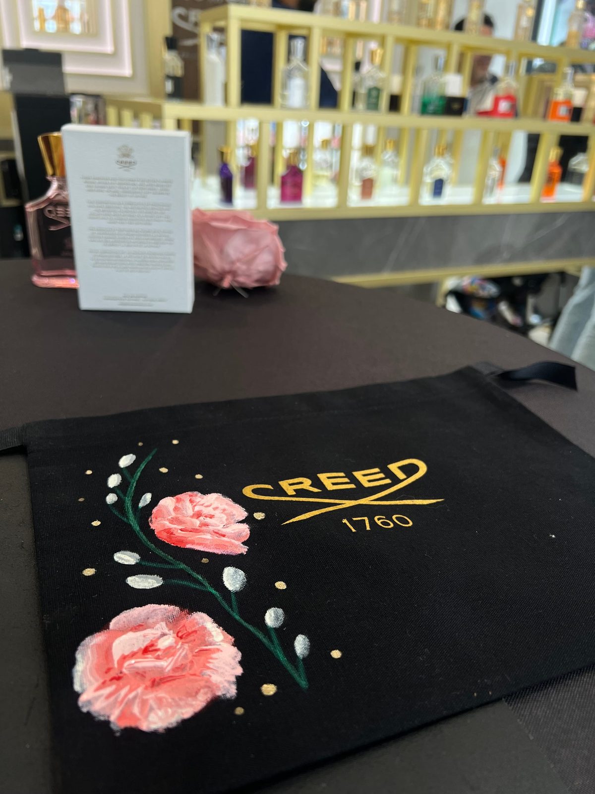 Gold lettering added to a fragrance bottle