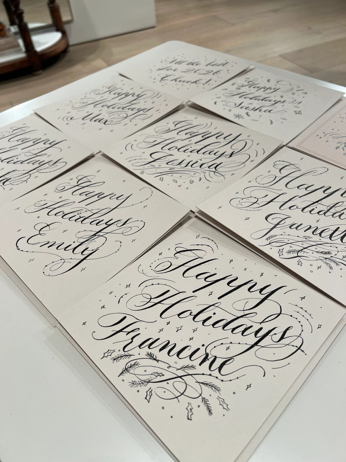 Flourished holiday calligraphy in black ink on white paper