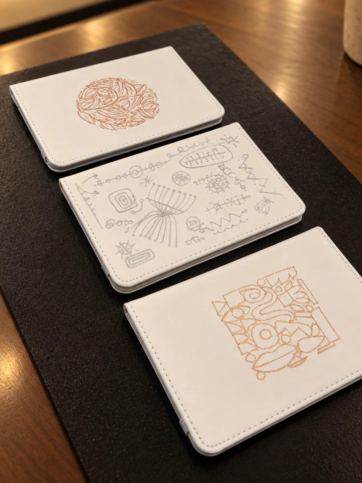 Fine architectural and botanical illustration on a small white notebook