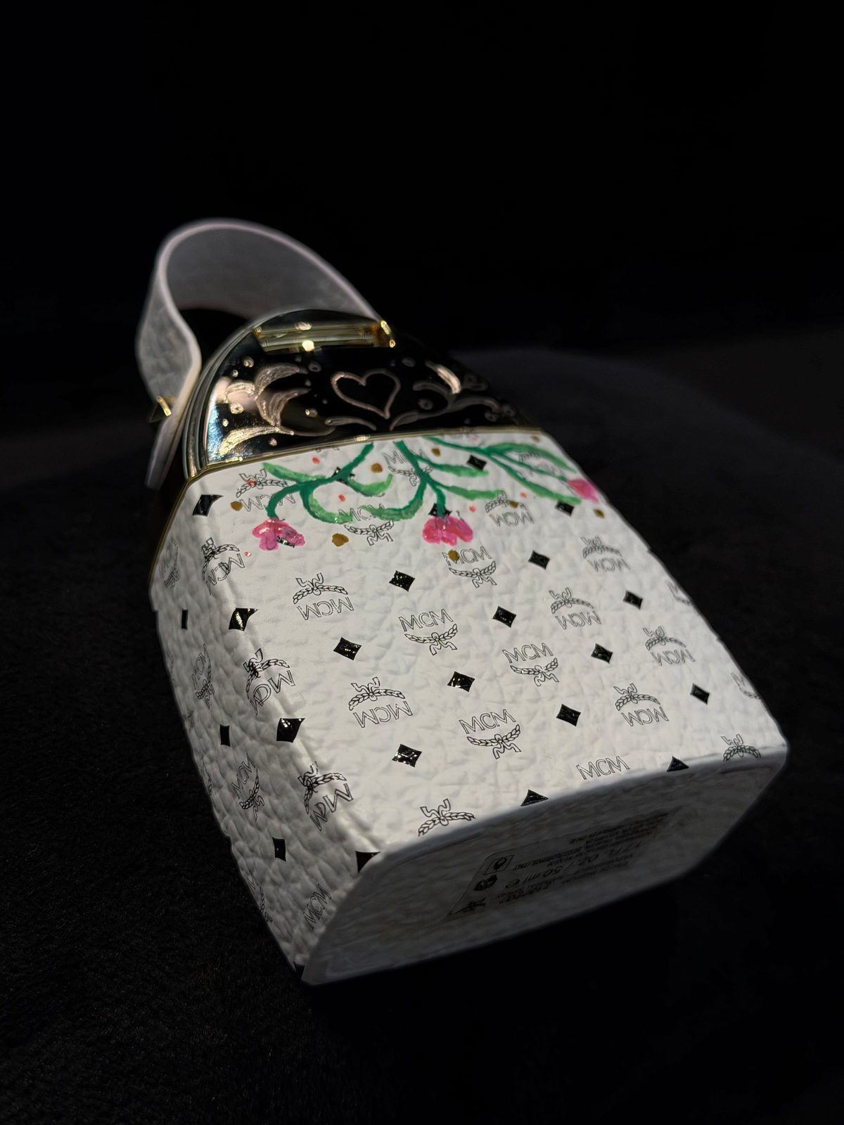 Fine brushwork adding initials to leather