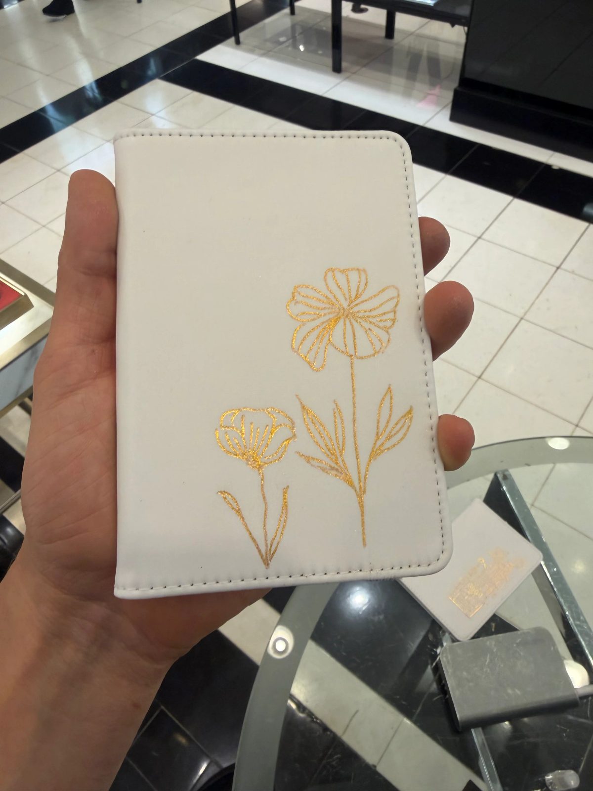 Fine architectural and botanical illustration on a small white notebook