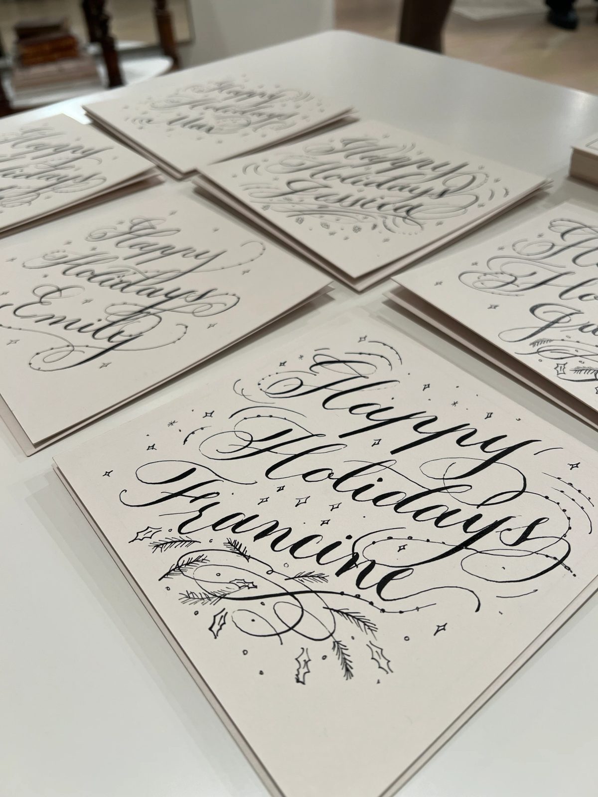 Flourished holiday calligraphy in black ink on white paper