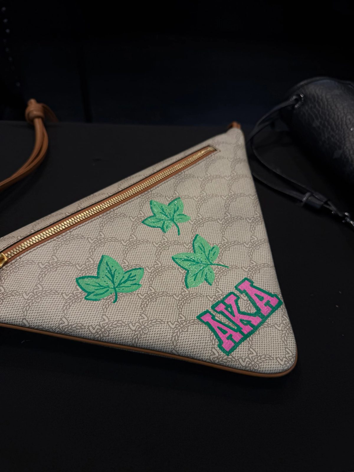 Hand-painted lettering and motifs on leather goods