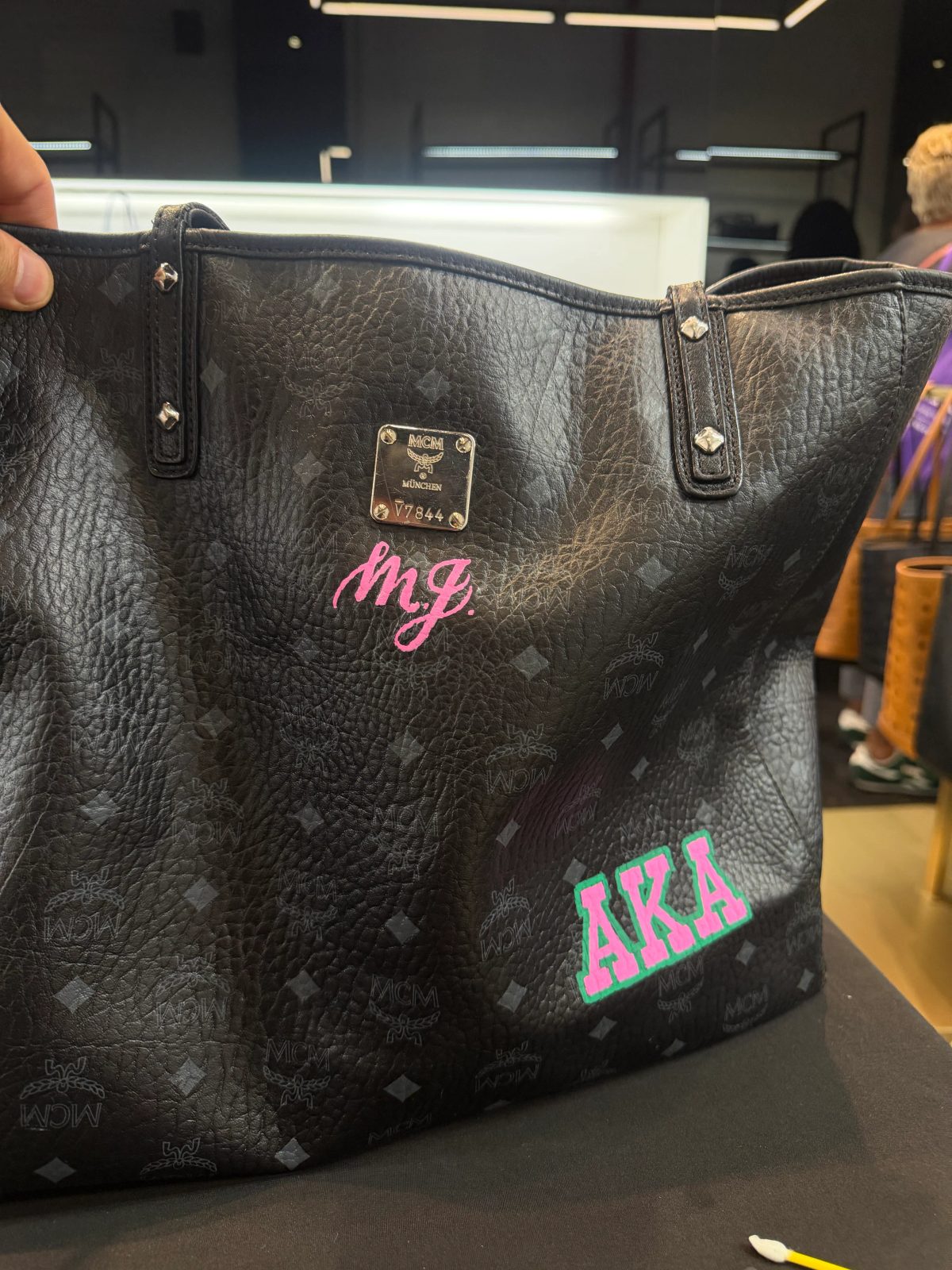 Hand-painted lettering and motifs on leather goods