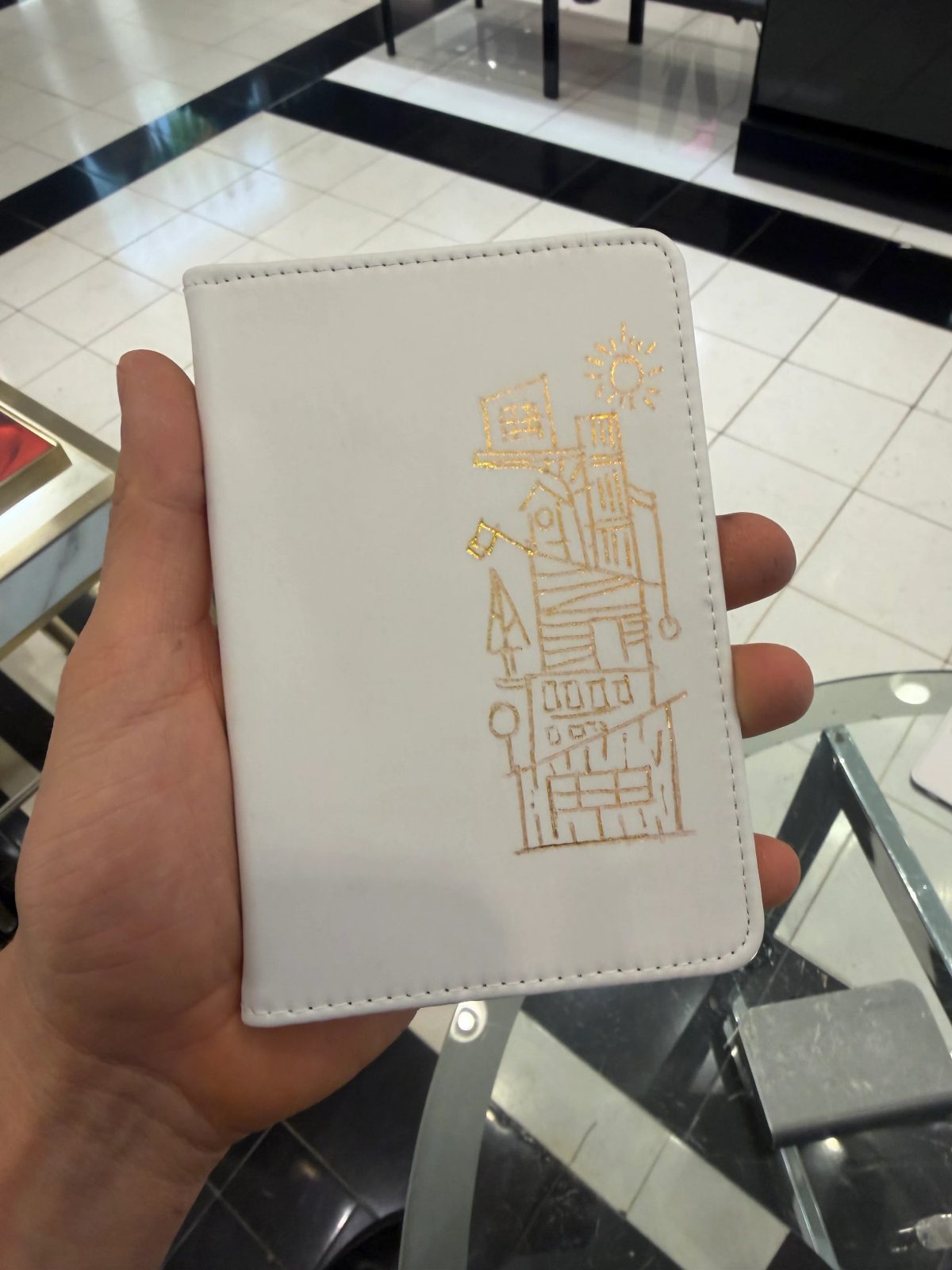 Fine architectural and botanical illustration on a small white notebook