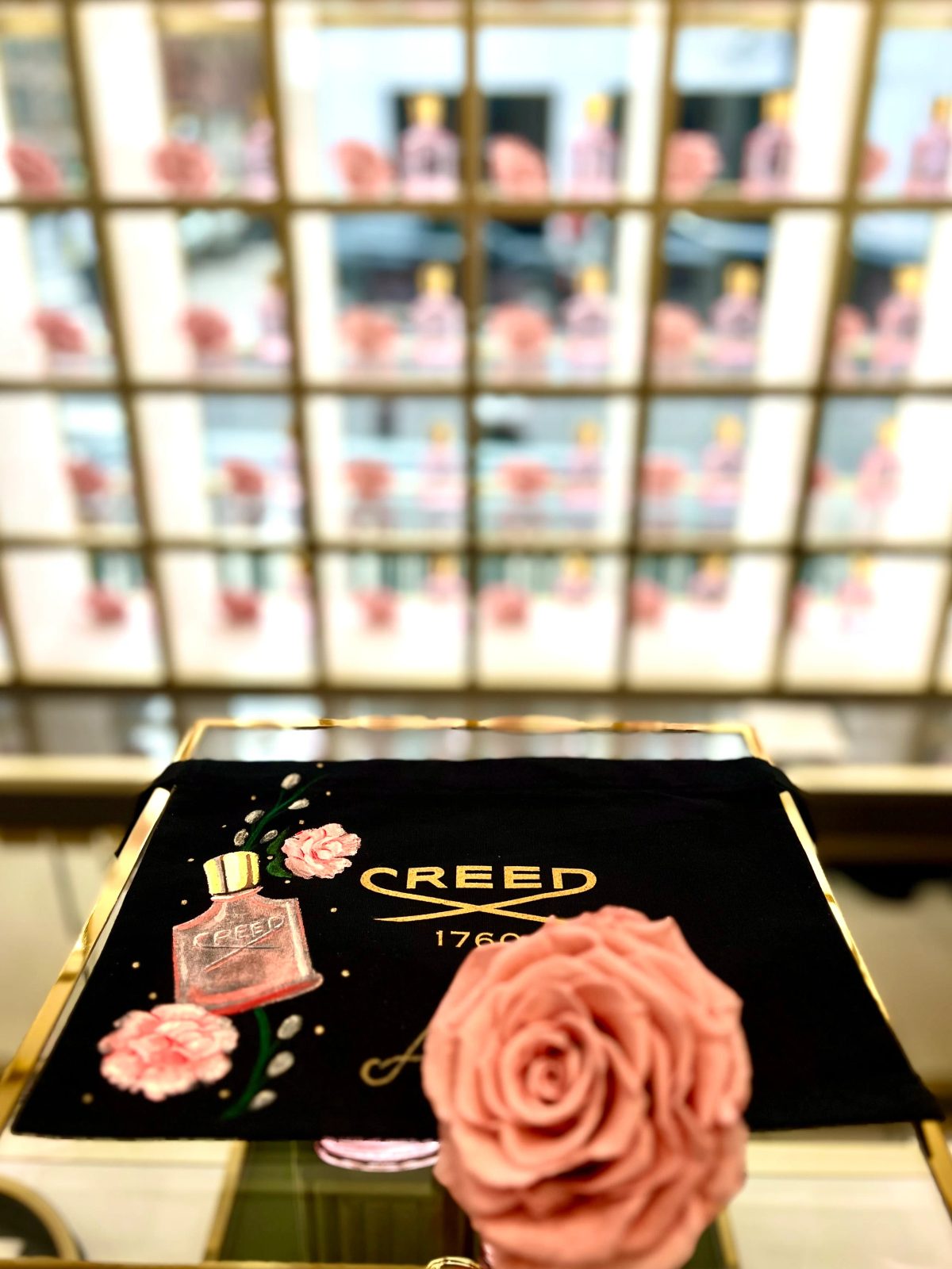 Painted flowers and personalized lettering on black fragrance packaging
