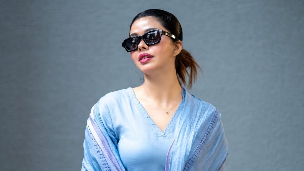 Creator Tashya wearing a stylish pastel blue ethnic outfit with oversized sunglasses, posing in a modern fashion portrait