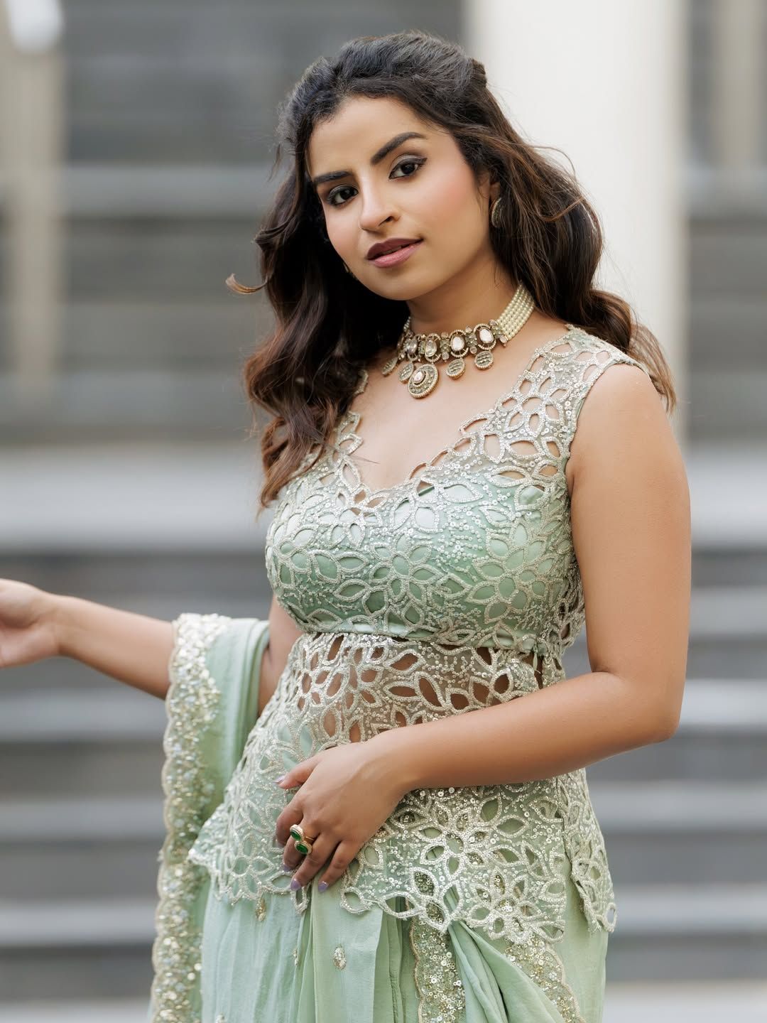 Creator Sivaangi Krishnakumar wearing a pastel green embroidered ethnic outfit with statement jewelry, posing outdoors