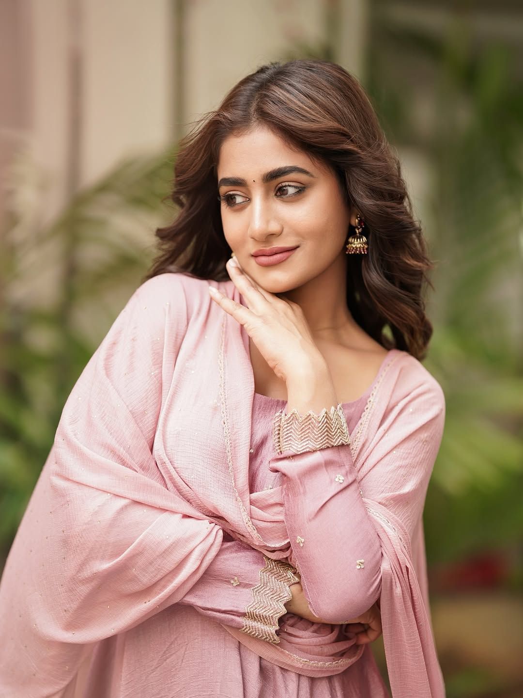 Creator Nayani Pavani wearing a soft pink traditional outfit with elegant jewelry, posing outdoors with a graceful expression