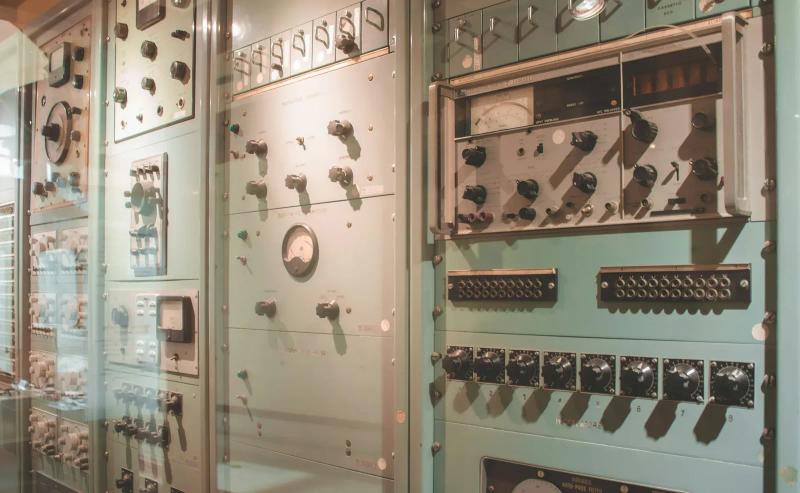 Vintage control panels and measuring instruments on display in a museum of technology