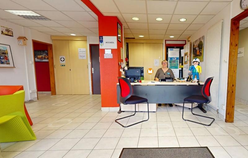 School reception, a secretary behind the counter