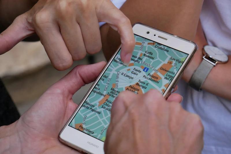 Hands scrolling a city map on a smartphone screen