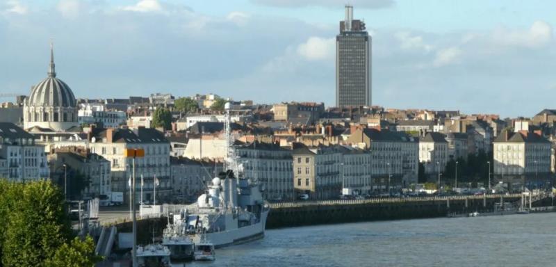 Banks of the Loire in Nantes with the Tour Bretagne and a moored ship