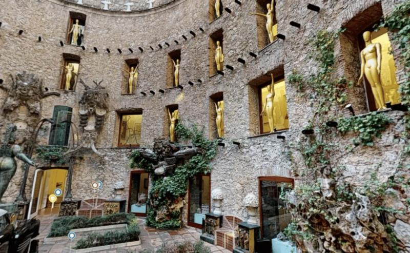 Courtyard of the Dalí Theatre-Museum in Figueres, with gold statues in the wall niches