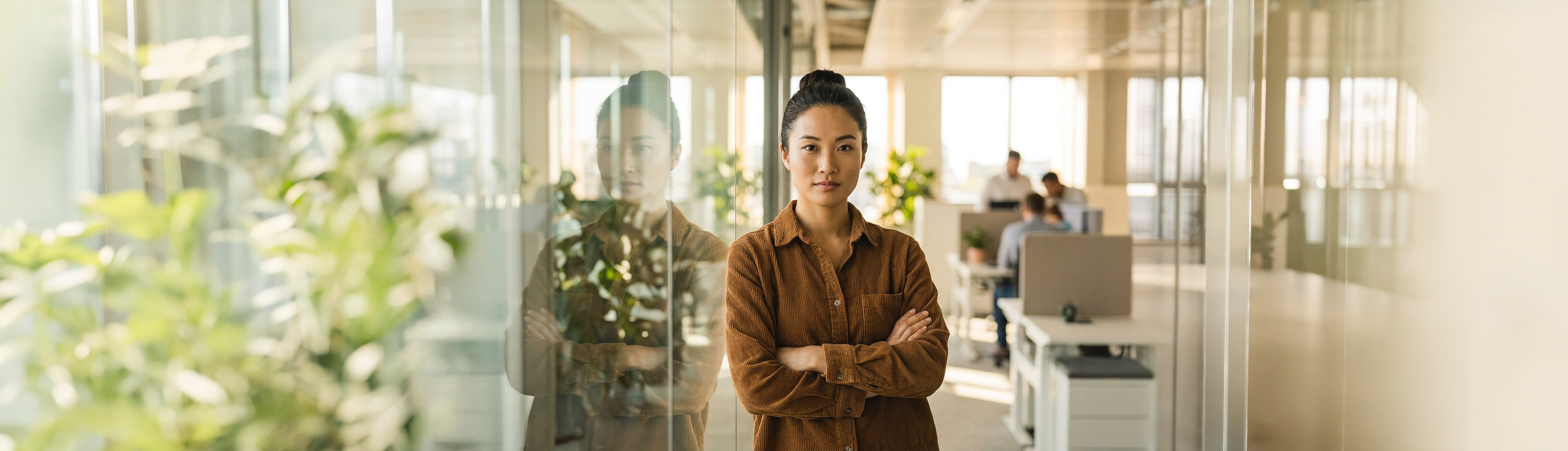 A specialist standing beside a reflective window