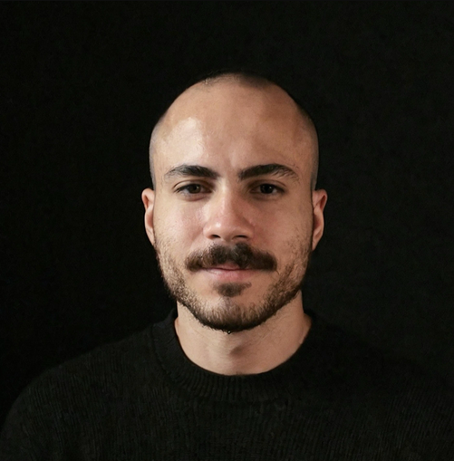 a man with a beard is wearing a black sweater