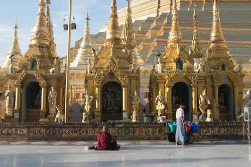 Praying at the Shwedagon Pagoda just after sunrise
