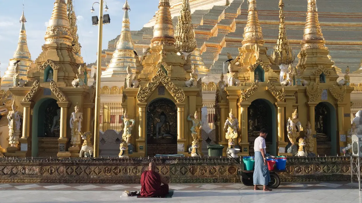 Praying at the Shwedagon Pagoda just after sunrise