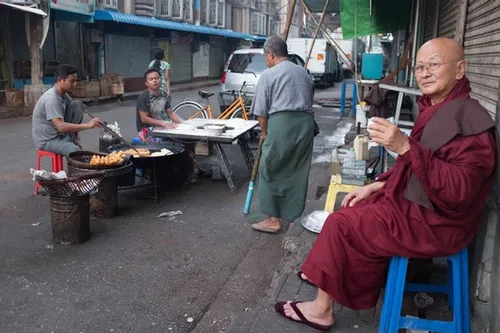 Early morning breakfast. Drinking tea on the side of the street