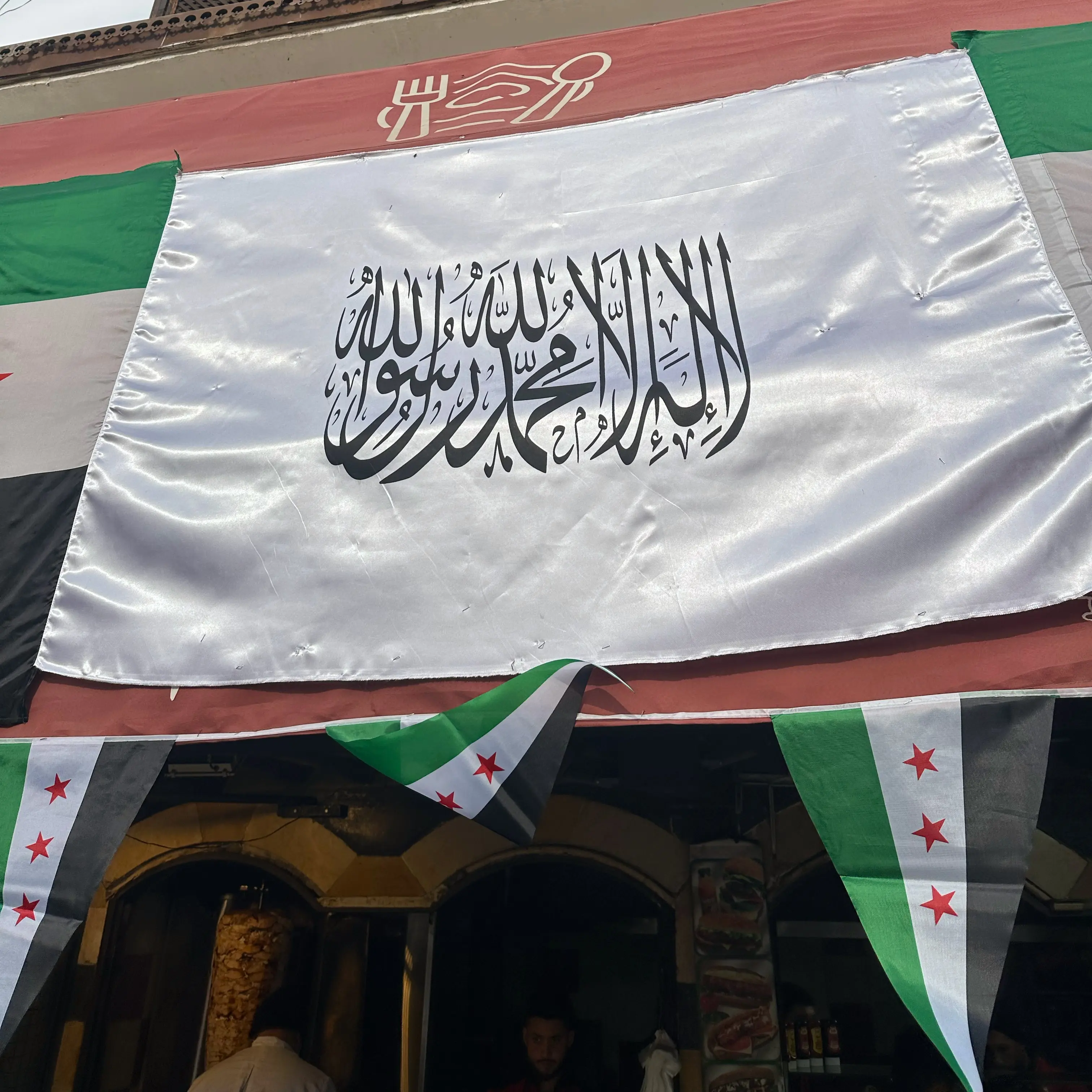 Al-nusra flag hanging on a shawarma shop