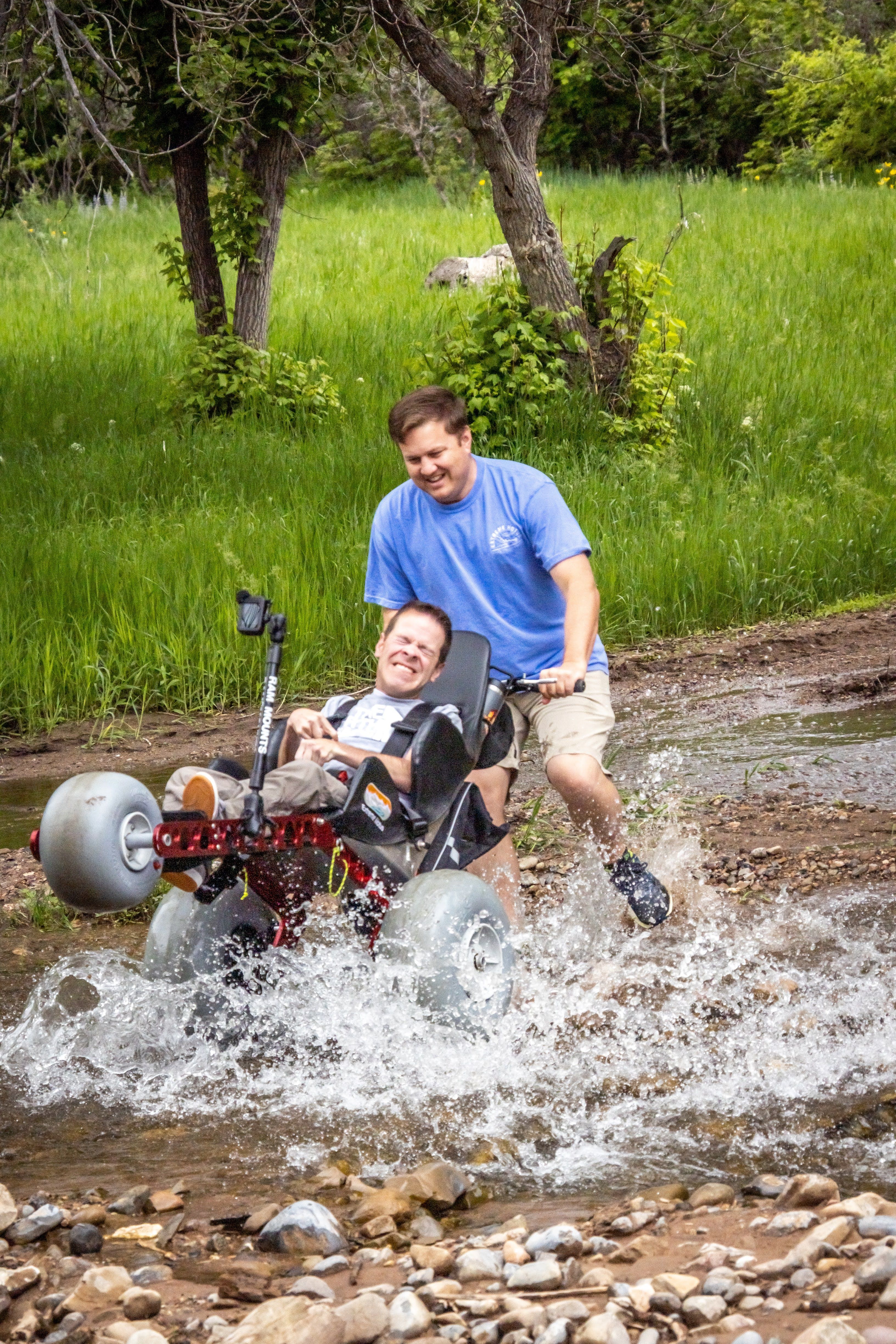 Extreme Motus All-terrain wheelchair splashing through the water