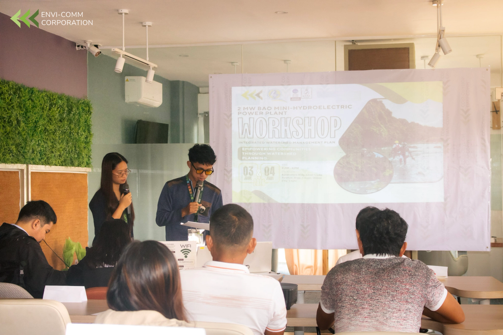Two presenters opening a workshop on a mini hydroelectric power plant