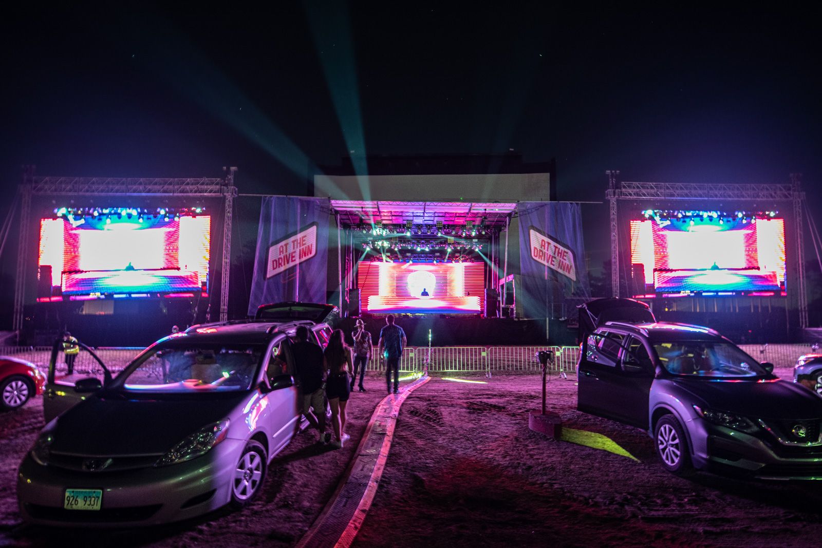2 Cars left to right a toyota prius and a nissan altima parked away from the stage at McHenry Outdoor Theater