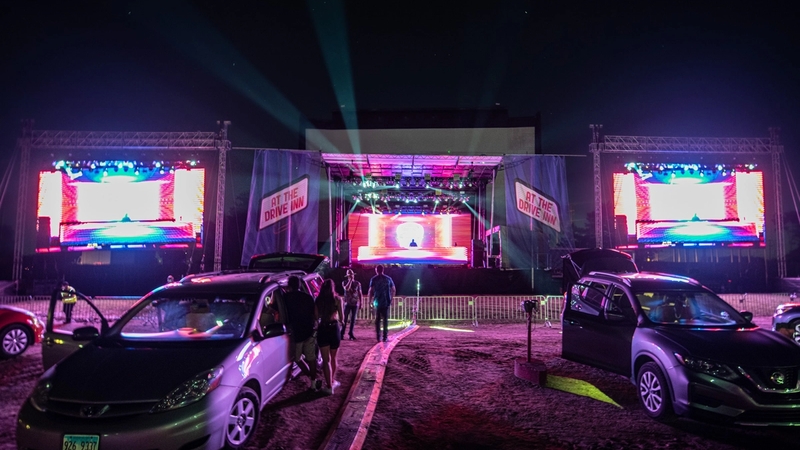 2 Cars left to right a toyota prius and a nissan altima parked away from the stage at McHenry Outdoor Theater