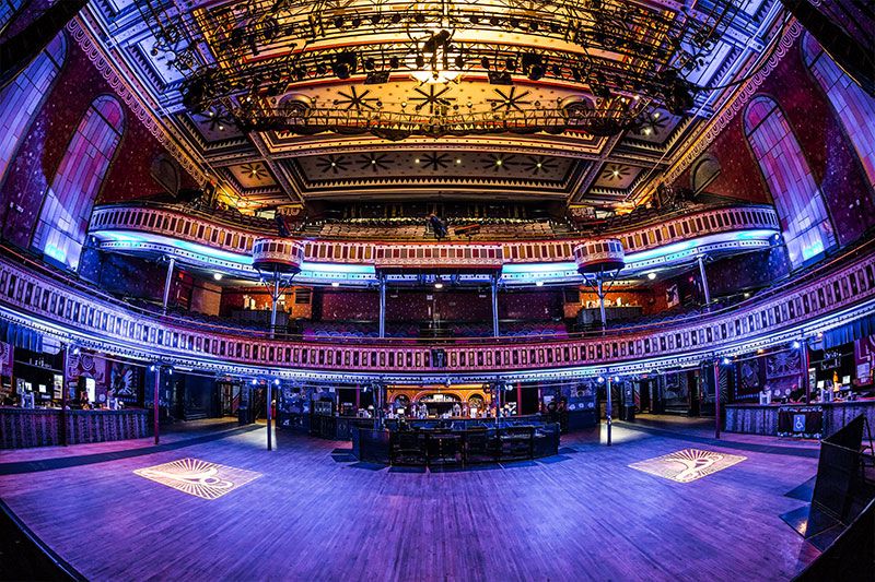 Stage point of view shot of the Tabernacle main room. The lights are blue and illuminate the entire room making it look purple.