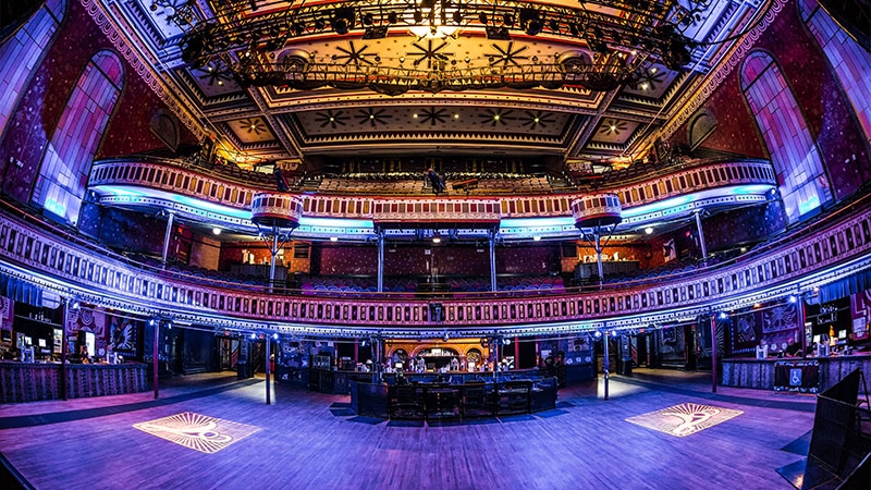 Stage point of view shot of the Tabernacle main room. The lights are blue and illuminate the entire room making it look purple.