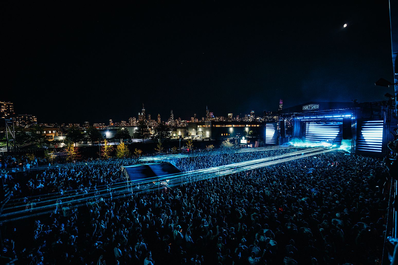 Outdoors at Salt Shed Chicago with the skyline in the background at night
