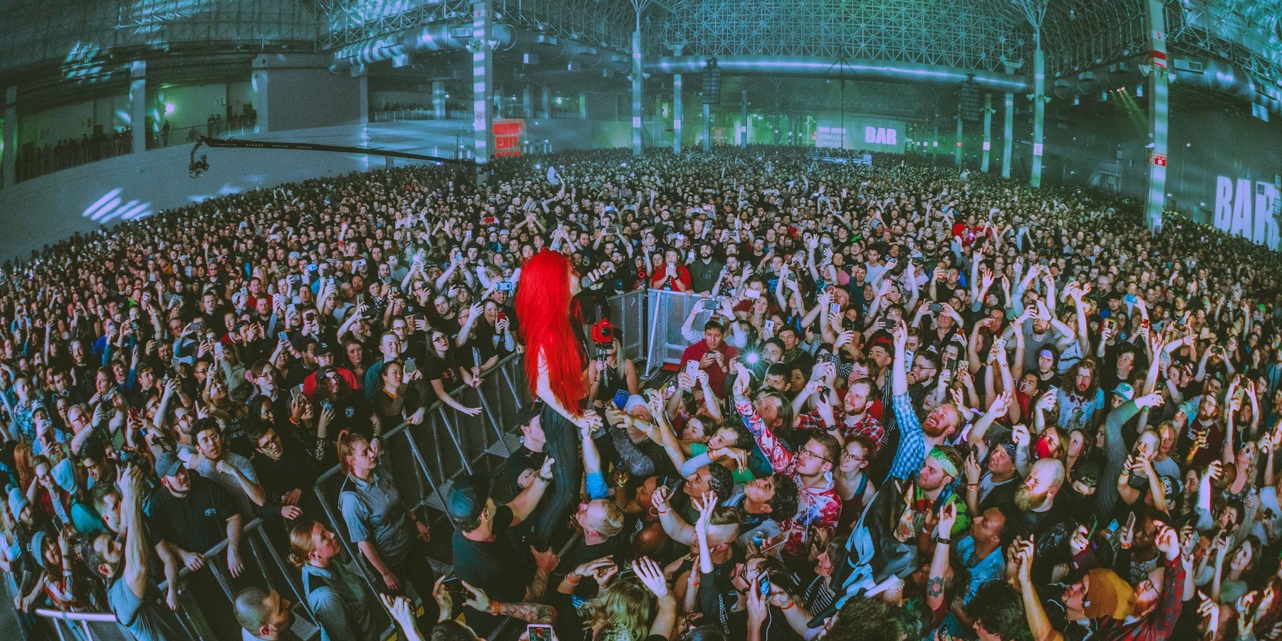 The female singer "LIGHTS" standing in the large crowd at the Navy Pier for Deadmau5 Cube V3 tour.