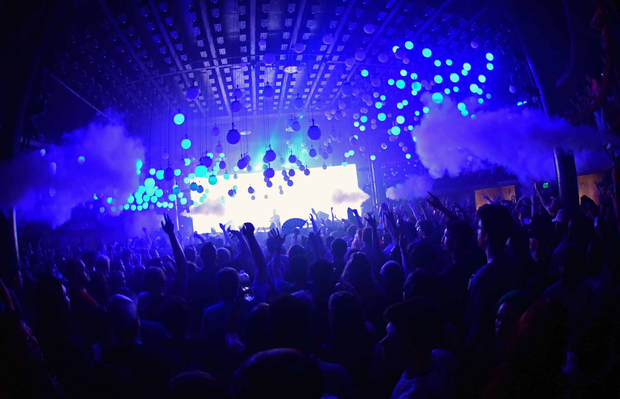 District night club in Atlanta with fans in front of a dj booth