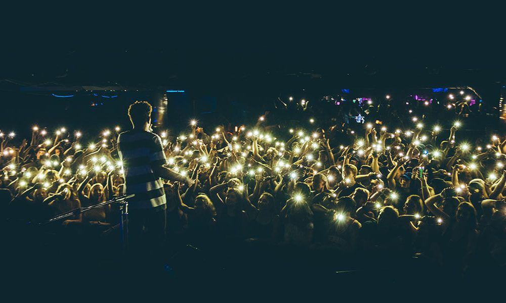 Liquid Madison venue with Bryce Vine on stage and a dark crowd holding up cell phone lights