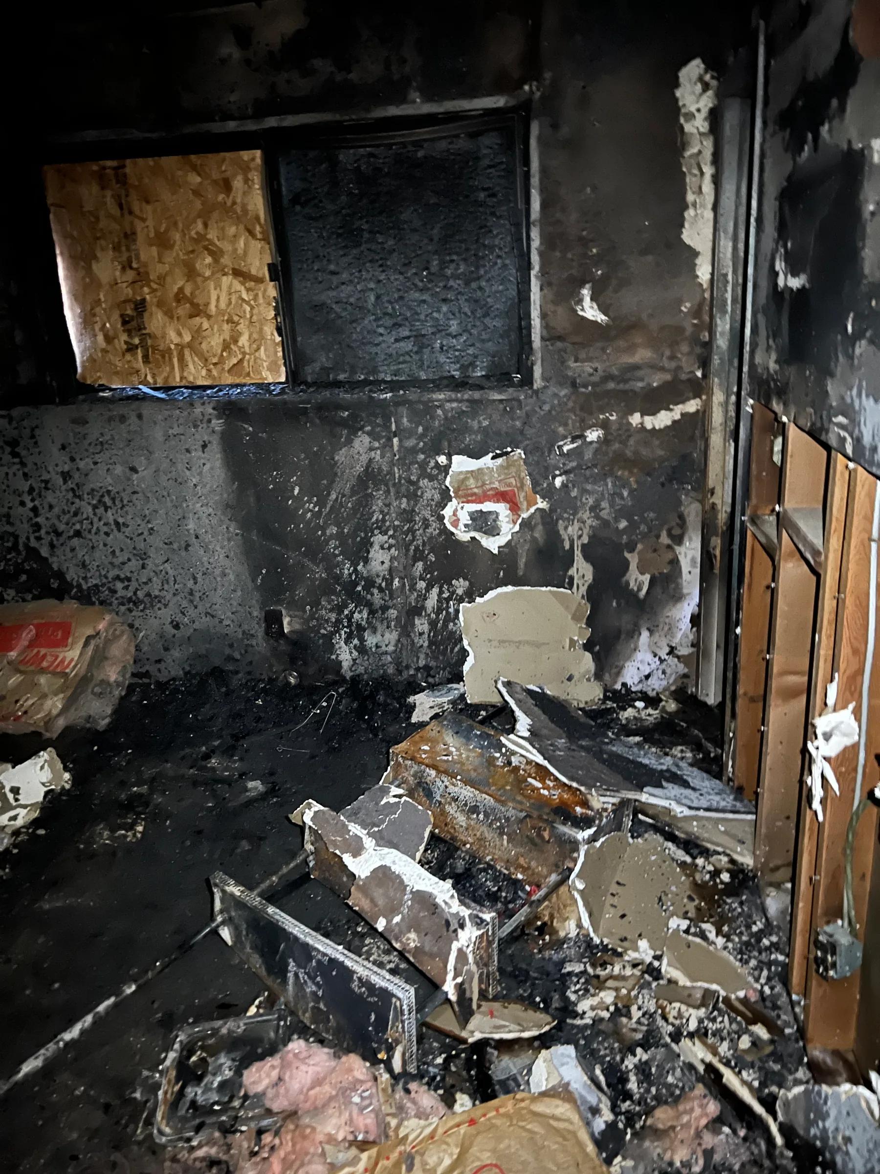 Charred room with debris before fire damage cleanup