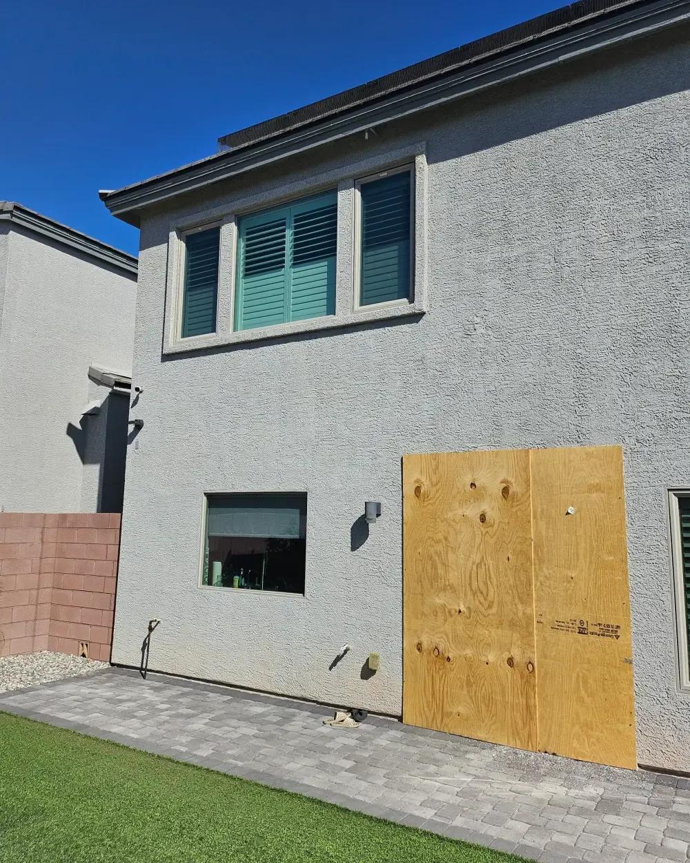Exterior board-up after vandalism and broken glass damage in Henderson, NV