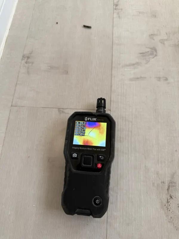 Thermal imaging camera display showing moisture behind drywall during water damage inspection in Henderson, NV