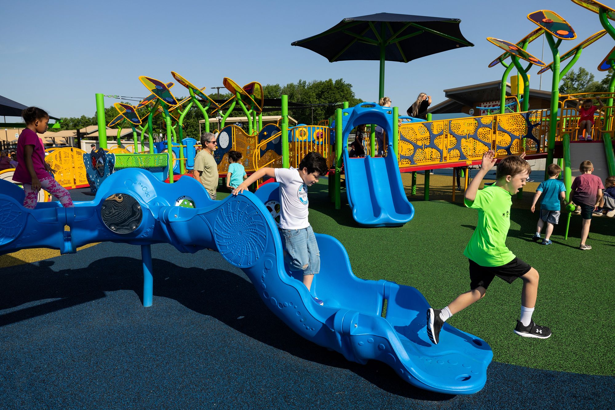 Kids run around the accessible playground at the Kevin Hammersmith Memorial Park 