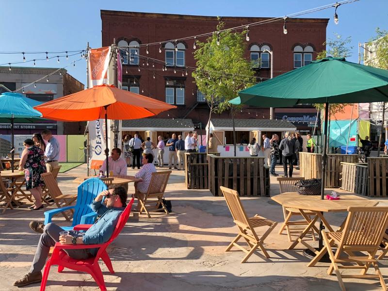 Community members enjoy pop-up outdoor seating, lighting, and sun shades. 