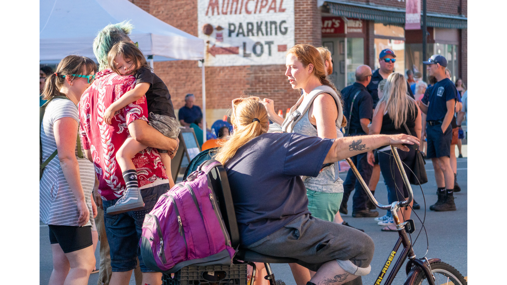 St. Johnsbury Final Fridays event series people gather on the street talking to one another.