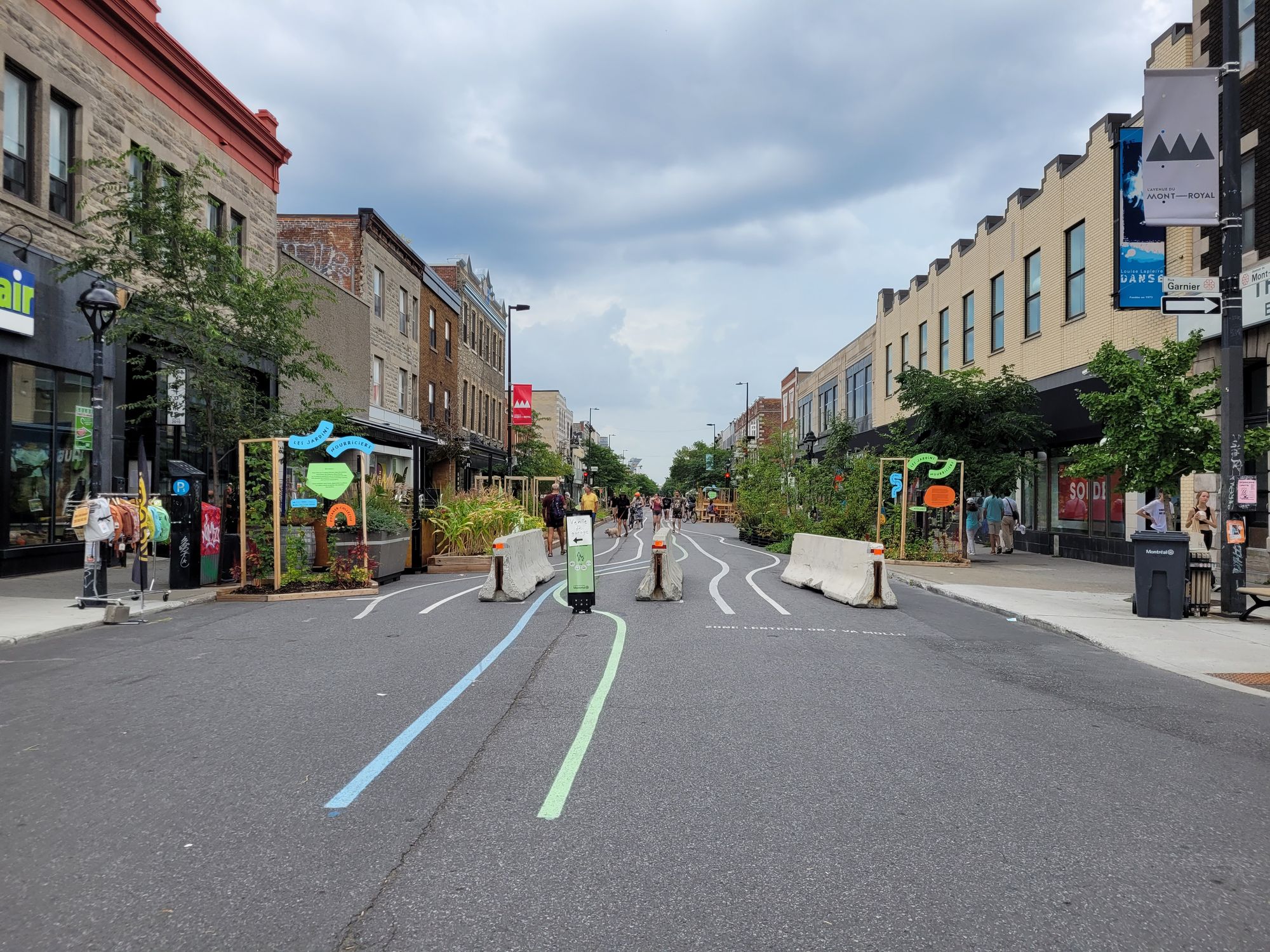 A ground mural of lines ebbs and flows down the road of Mont-Royal Avenue.