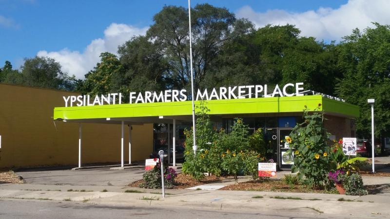 Ypsilanti Farmers MarketPlace exterior with large bold lettering on the roof of the building stating it so.