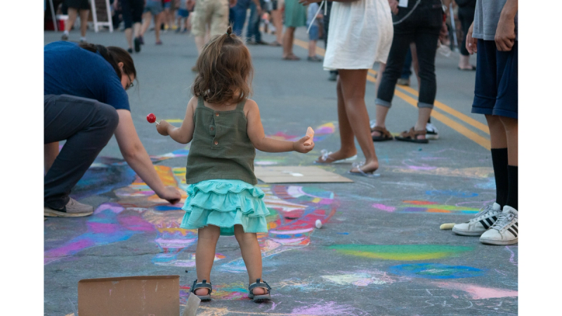 St. Johnsbury Final Fridays event series where a child plays with sidewalk chalk.